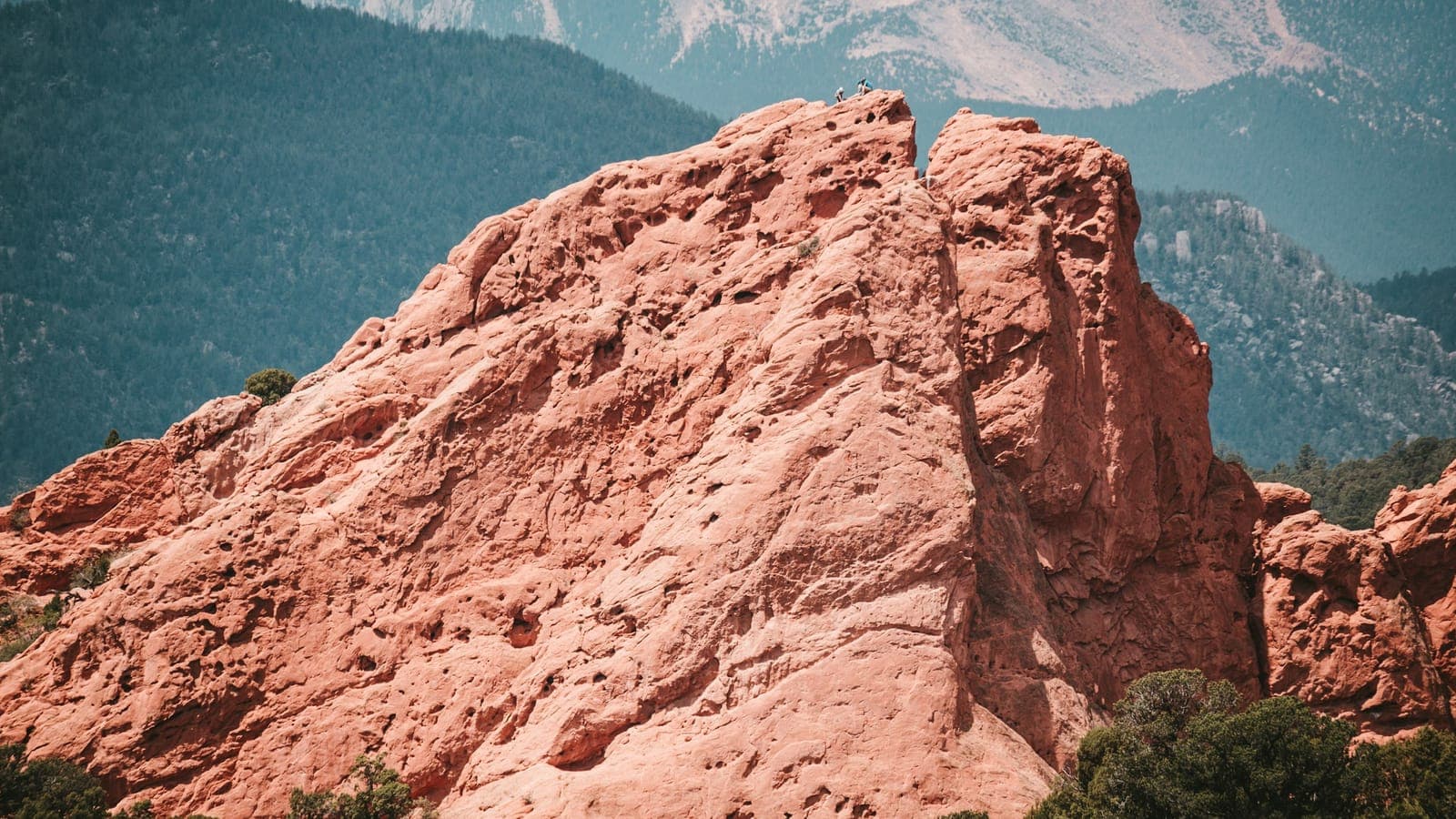 Pikes Peak rising above Garden of the Gods red rock formations near Colorado Springs at sunrise