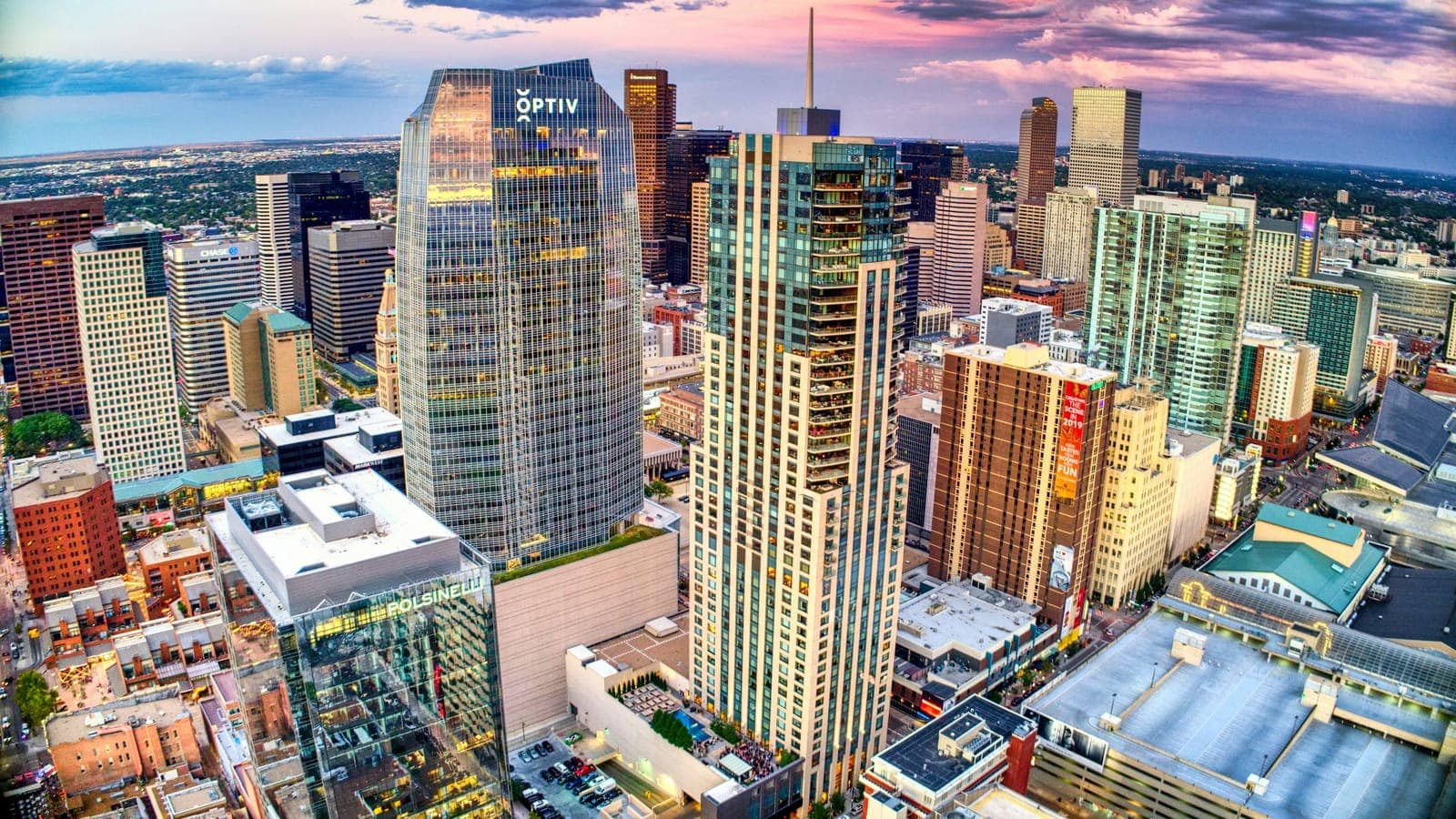 Denver storefront on a sunny morning with the downtown skyline behind it
