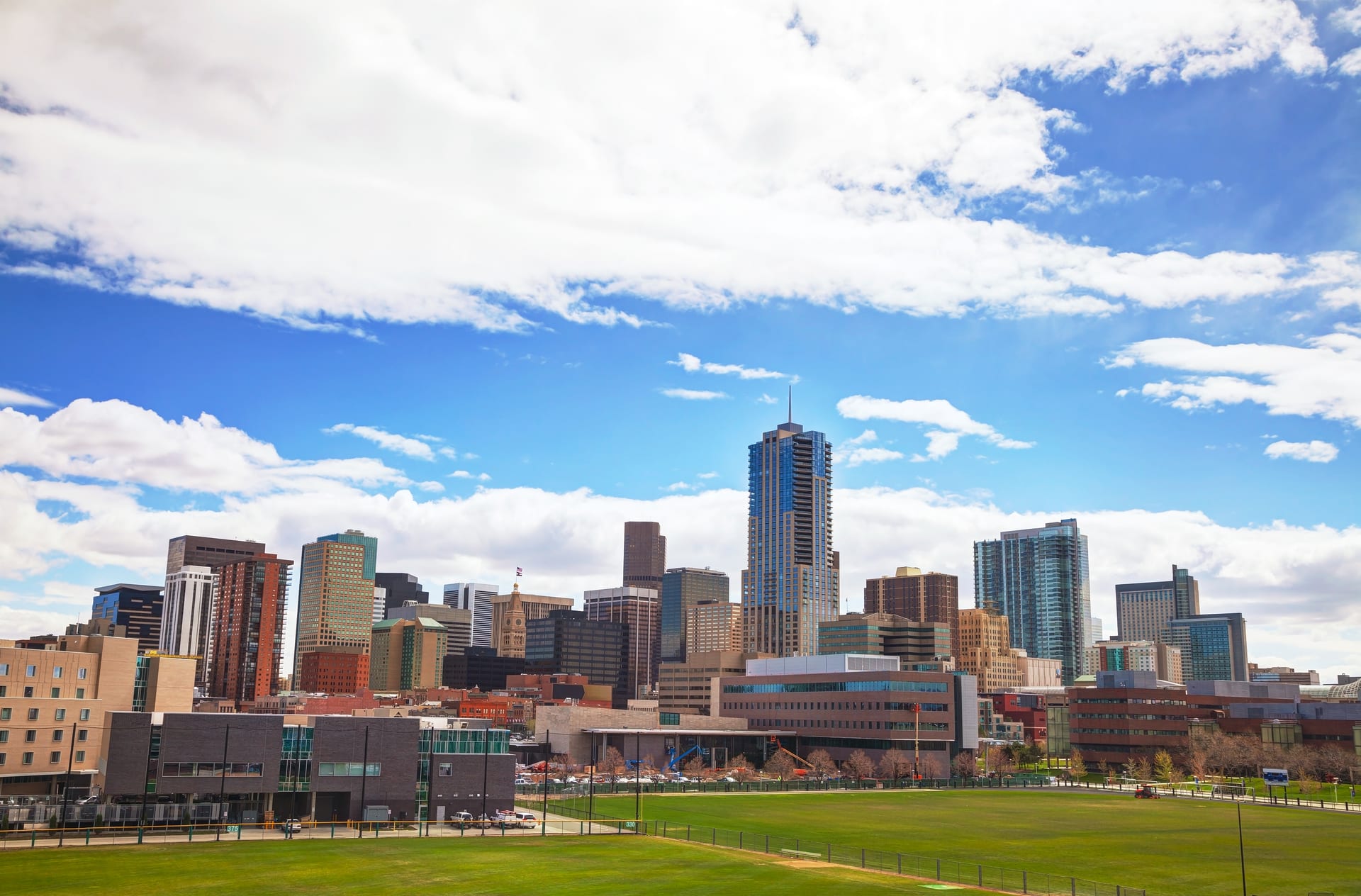 Denver skyline with the Rocky Mountains in the background, home of Exquisite Logistics Moving